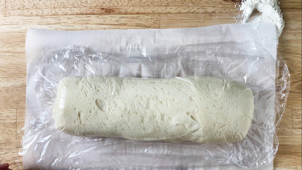 bread dough rising with plastic wrap