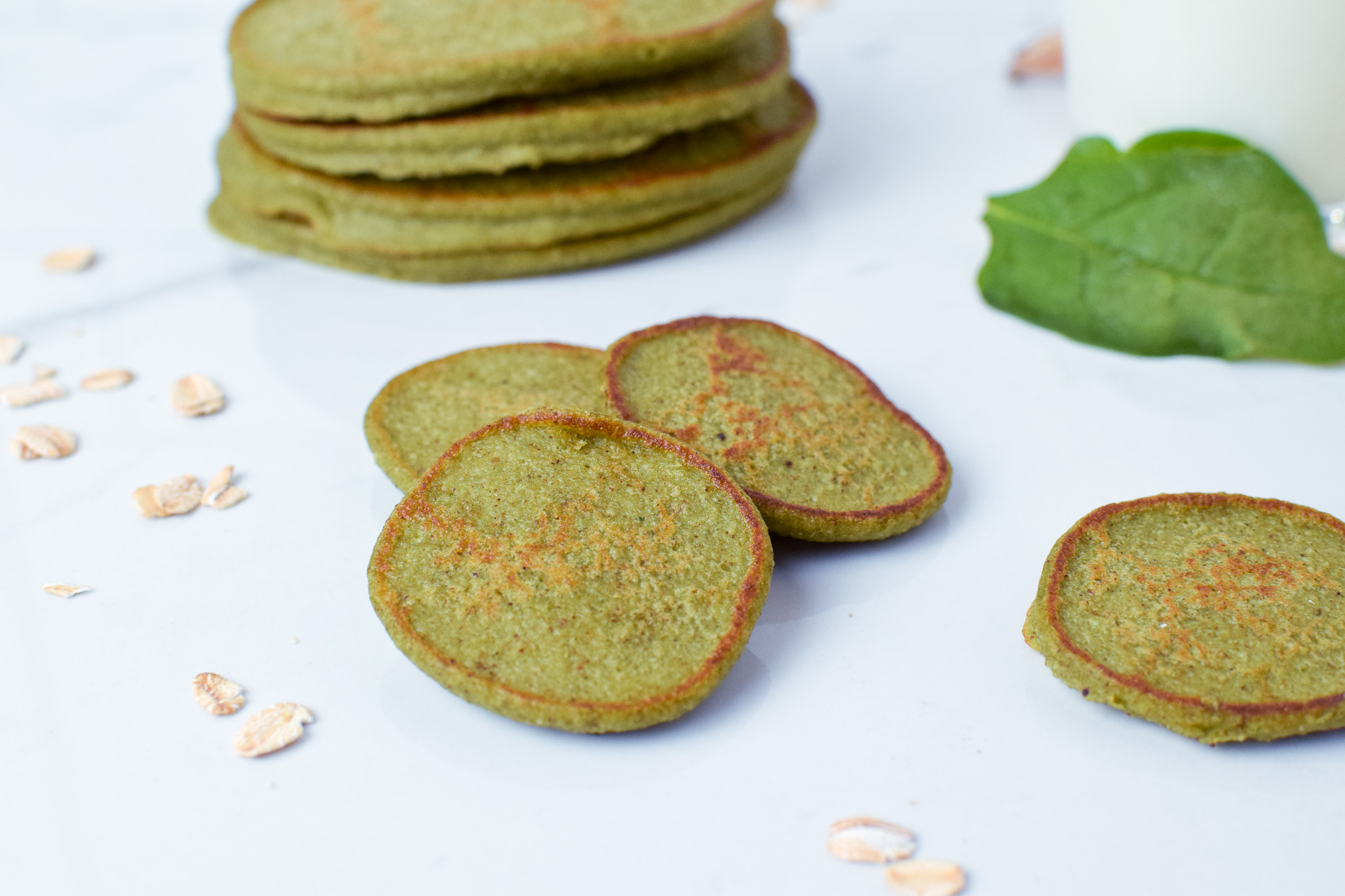 green pancakes with sprinkles of oats