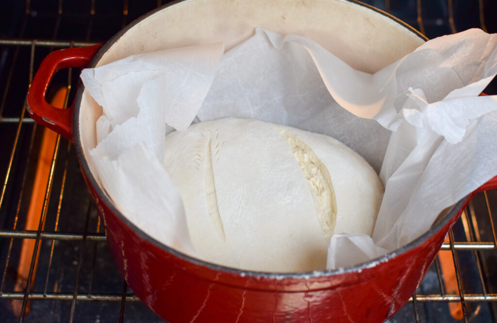 sourdough bread in a dutch oven in the oven ready to be cooked