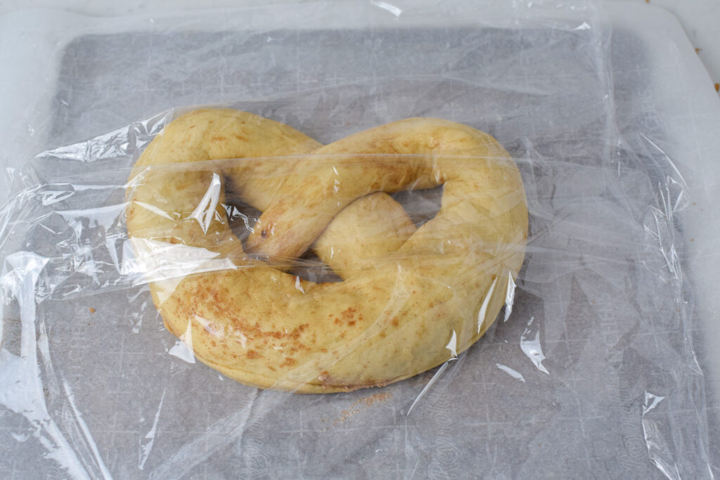 New Year's Pretzel dough under plastic wrap rising