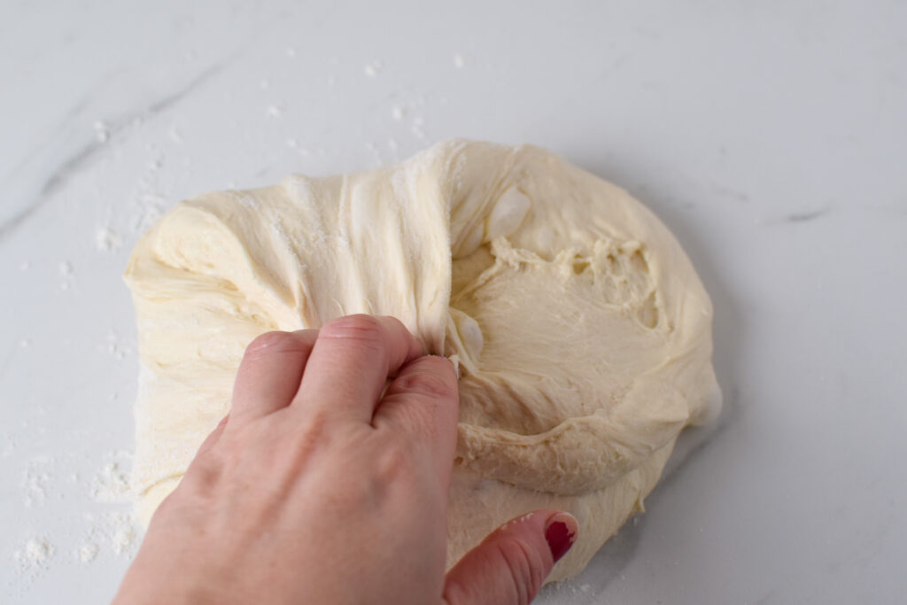 stretch and folding sourdough bread dough