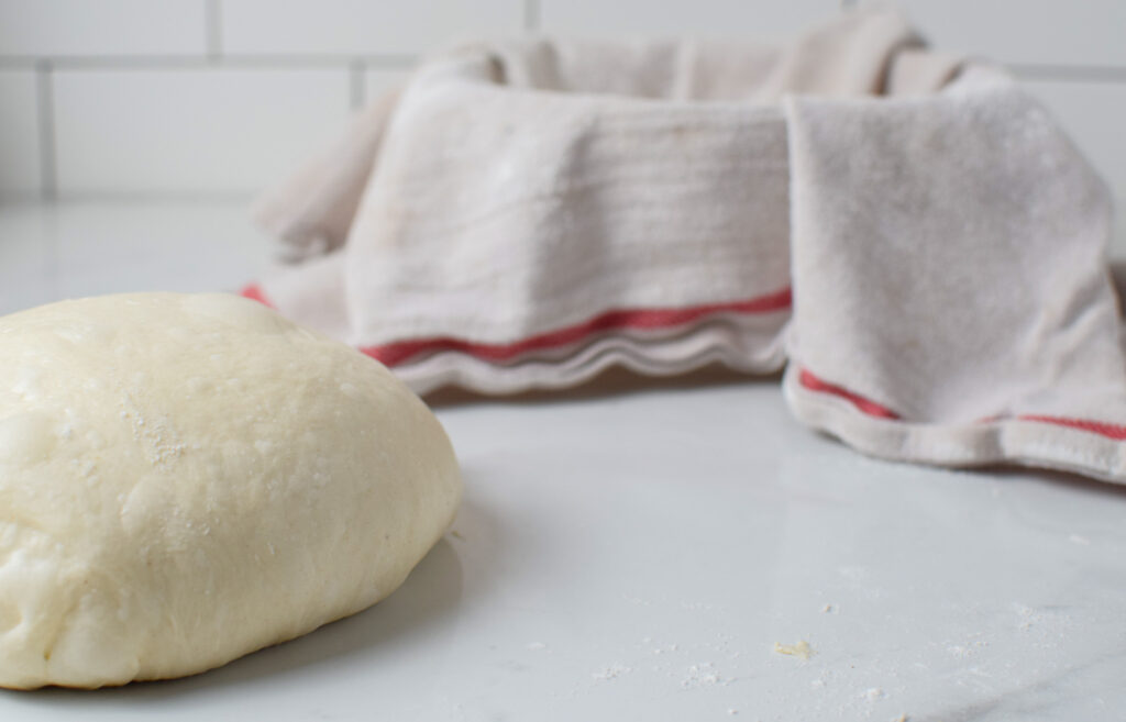 sourdough bread dough going in a banneton