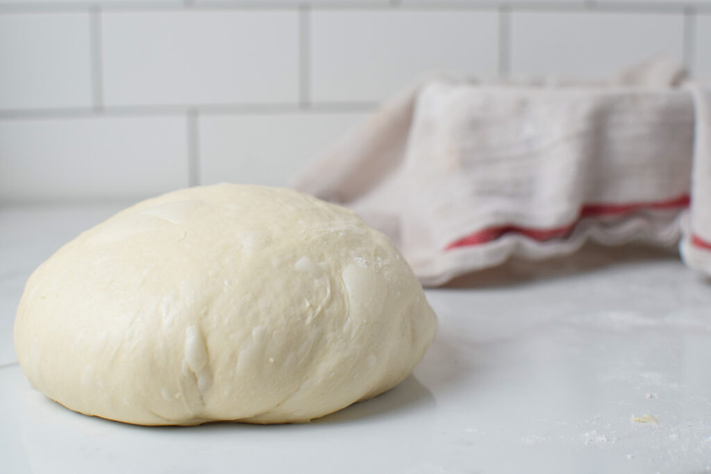 sourdough bread dough going in a banneton