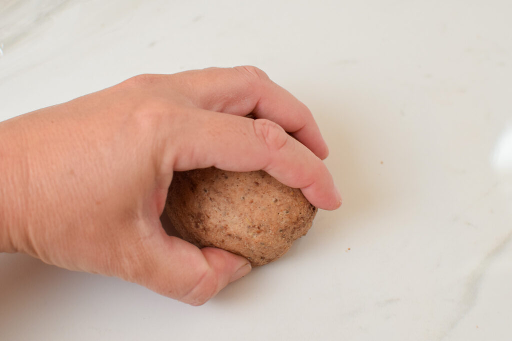 bagel dough being formed by hand