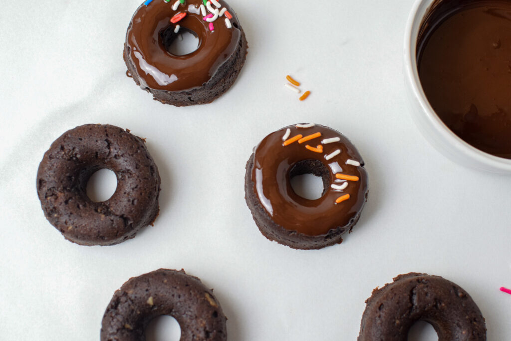 healthy mini donuts being covered in chocolate 