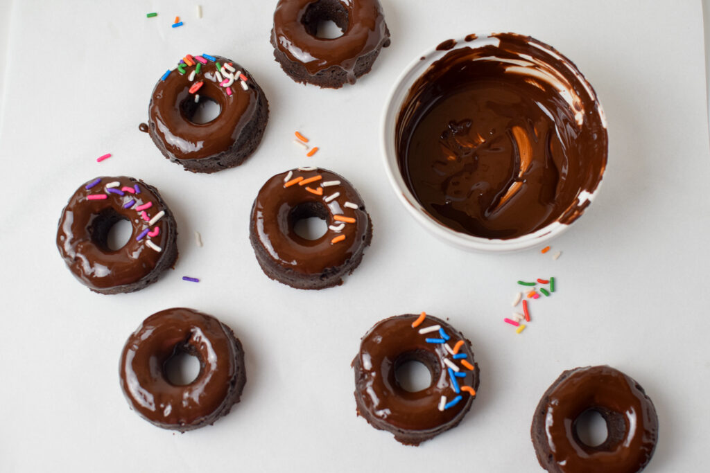 donuts being covered in chocolate